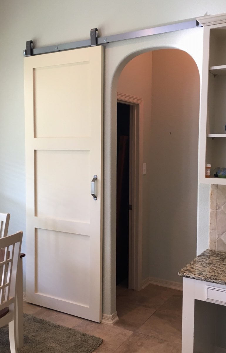 White sliding barn door used as bedroom door 